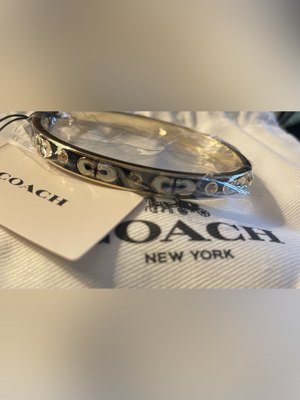 Coach Gold-Tone Bangle with Black and Cream Enamel Accents…(dust bag included)